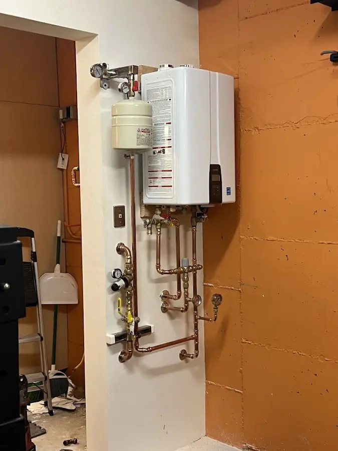 Plumbing technician inspecting water heater connections in Pepperdine University